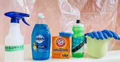 several cleaning products are lined up on a counter