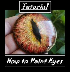 a hand holding up a glass eye with the words how to paint eyes on it