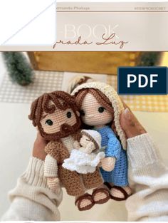 a knitted doll holding a baby jesus in her arms with the text book made big