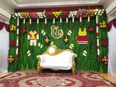 a stage set up for a wedding with flowers and decorations on the wall behind it