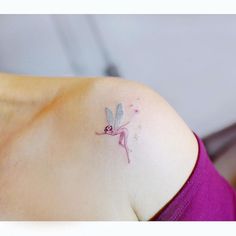 a woman with a small tattoo on her shoulder