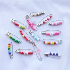 several different colored clips are arranged on a white surface