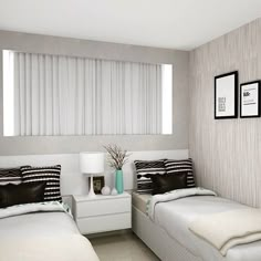 two beds in a bedroom with white and black bedding