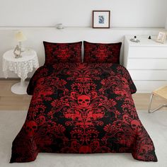 a red and black bed with skulls on it