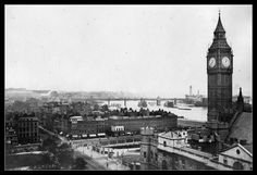 an old black and white photo of a city with a clock tower in the middle