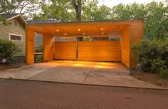 an open garage with lights on the side and trees in the backgrouund