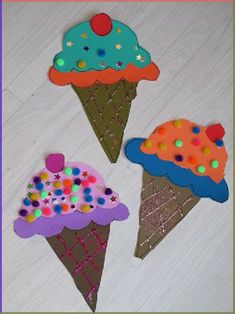 three ice cream cones with sprinkles on them