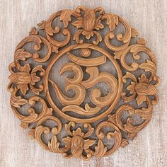 an intricately carved wooden plaque with the number 5 in it's center surrounded by flowers and leaves