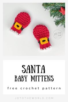 two crocheted santa baby mittens on top of a white table with pine branches