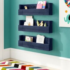 three blue wooden shelves on the wall in a child's room