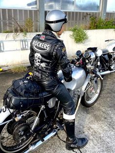 a man sitting on top of a motorcycle