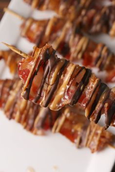 several skewers with chocolate drizzled on them