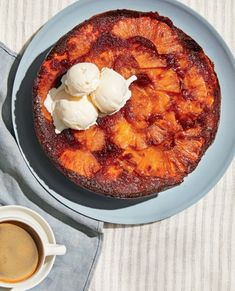 a pineapple upside down cake on a plate with ice cream in the top corner