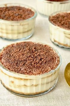 four desserts in glass dishes on a table