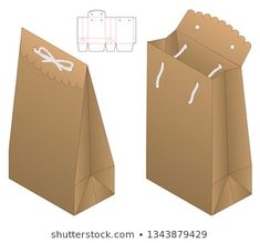 an open brown paper bag with white string on the side and another box in the back