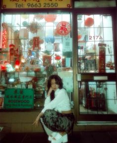 a woman standing in front of a store