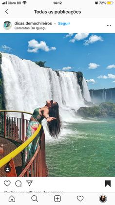 a woman standing in front of a waterfall