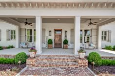 a front porch with brick steps and potted plants