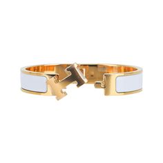 Hermes Clic H Bracelet featured in white Enamel.Set in Gold plated hardware.Chic, modern and unmistakably Hermes!A hinged band allows the H to swivel and open the bracelet.Comes with pouch and signature Hermes box.NEW or NEVER WORN.final saleSIZE: PM or SmallBRACELET MEASURES: DIAMETER 2.25"HEIGHT 0.47" CONDITION:NEW or NEVER WORN Hermes Clic H Bracelet, Pandora Bracelet Charms Ideas, H Bracelet, Bday List, Hermes Bracelet, Hermes Jewelry, Hermes Accessories, Hermes Box, Bracelet Charms