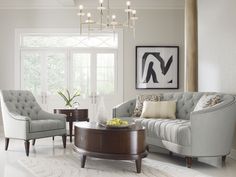 a living room filled with furniture and a chandelier