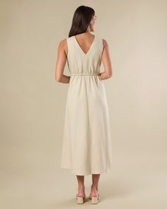 Lightweight and floaty in our summer-weight linen blend, this button-down midi dress is designed with a v-neck bodice featuring pintucked pleats and a cinched-in stretch waist. Pintuck pleat detail on bodice Encased elastic at waist Functional buttons at bodice only V-neckline Midi length Flowy skirt 60% Tencel 20% Linen 20% Cotton Machine wash with like colors. Do not bleach. Hang to dry. Iron warm. Summer Midi V-neck Dress With Tie Waist, Solid V-neck Midi Dress With Smocked Back, V-neck Maxi Dress With Gathered Waist For Daywear, Elegant V-neck Midi Dress With Elastic Waistband, Linen Midi Dress For Vacation, Summer Midi-length V-neck Dress For Work, Summer Midi V-neck Dress For Work, Summer Midi-length V-neck Workwear Dress, Spring Solid Color Midi Dress With Notched Neckline