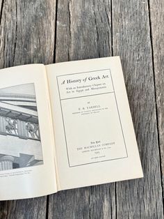 an open book sitting on top of a wooden table