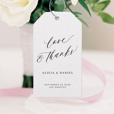 a close up of a tag on a bouquet of flowers with the words love and thanks written on it