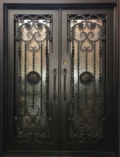 an ornate iron door with glass panels on the front and side doors, in black