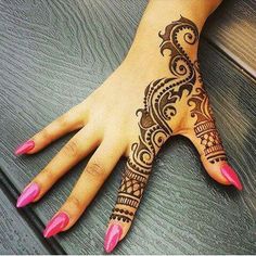 a woman's hand with henna on it and pink nails in the middle