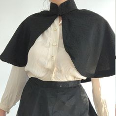 This wonderful textile is an antique French capelet, dating to the late 1800s. The black material is a beautiful textured silk blend fabric. This textile would have been worn about the shoulders as a stylish accent. It fastens at the neck with 2 metal hook and eye clasps. The collar is lined with a heave linen to keep it stiff, you can see it becuase the black fabric has come loose at the back of the neck. The rest of the cape is not lined, but the simple seams are reinforced with a kind of nett Black Capelet For Evening Wear, Formal Black Capelet, Black Capelet For Costume, Fitted Black Capelet, Black Fitted Capelet, Elegant Black Capelet For Costume, Elegant Black Formal Capelet, Capelet Outfit, Victorian Inspired Outfits