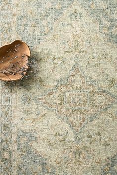 a large rug with an intricate design on the top and bottom is shown in light green