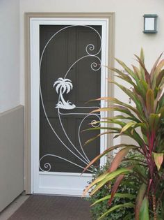 a door with a palm tree on it next to a potted plant and houseplant