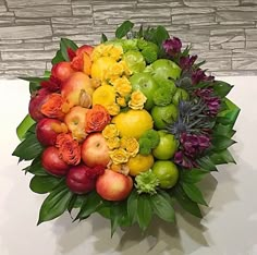 a bouquet of fruit and flowers on a table