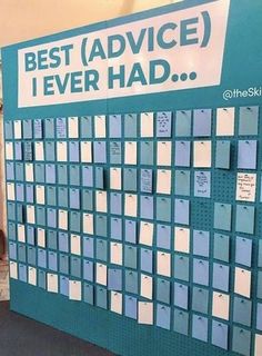 a large blue and white calendar on display in a room with two people standing next to it