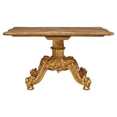 an ornately carved table with gold leaf accents