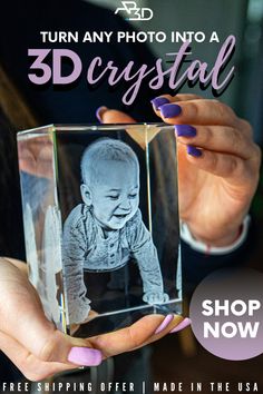 a woman holding up a glass block with a baby in it