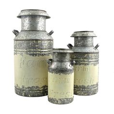 three metal canisters sitting next to each other