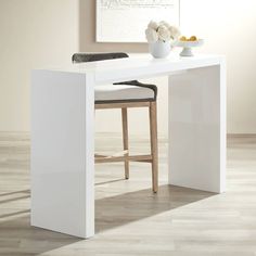 a white table with two stools in front of it