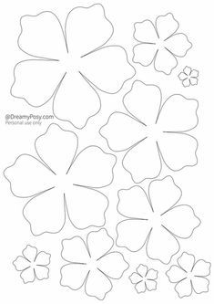 four leaf clovers cut out from paper and ready to be used as a craft project