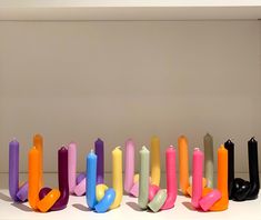 colorful candles are arranged in the shape of letters