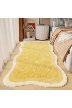 a yellow area rug on the floor in a room