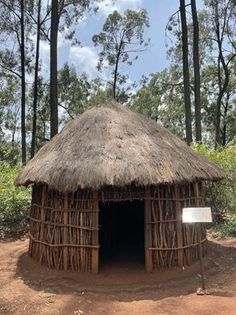 a small hut in the middle of some trees