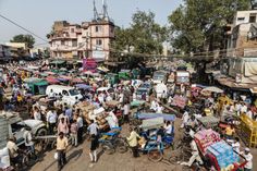 a crowded street with many people and vehicles