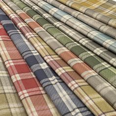 many different plaid fabrics are lined up together