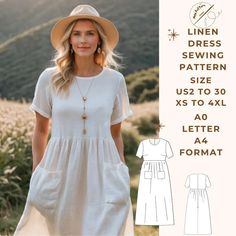 a woman wearing a white dress and hat standing in front of a field with mountains