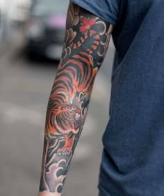 a man with a tiger tattoo on his arm