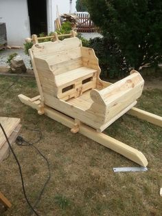 a wooden bench sitting on top of a grass covered field