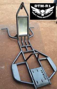 a metal frame with a mirror on it and some people in the background looking at it