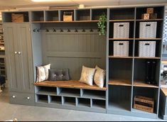 a room with some shelves filled with pillows and other items on it's sides