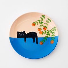 a blue plate with a black cat on it